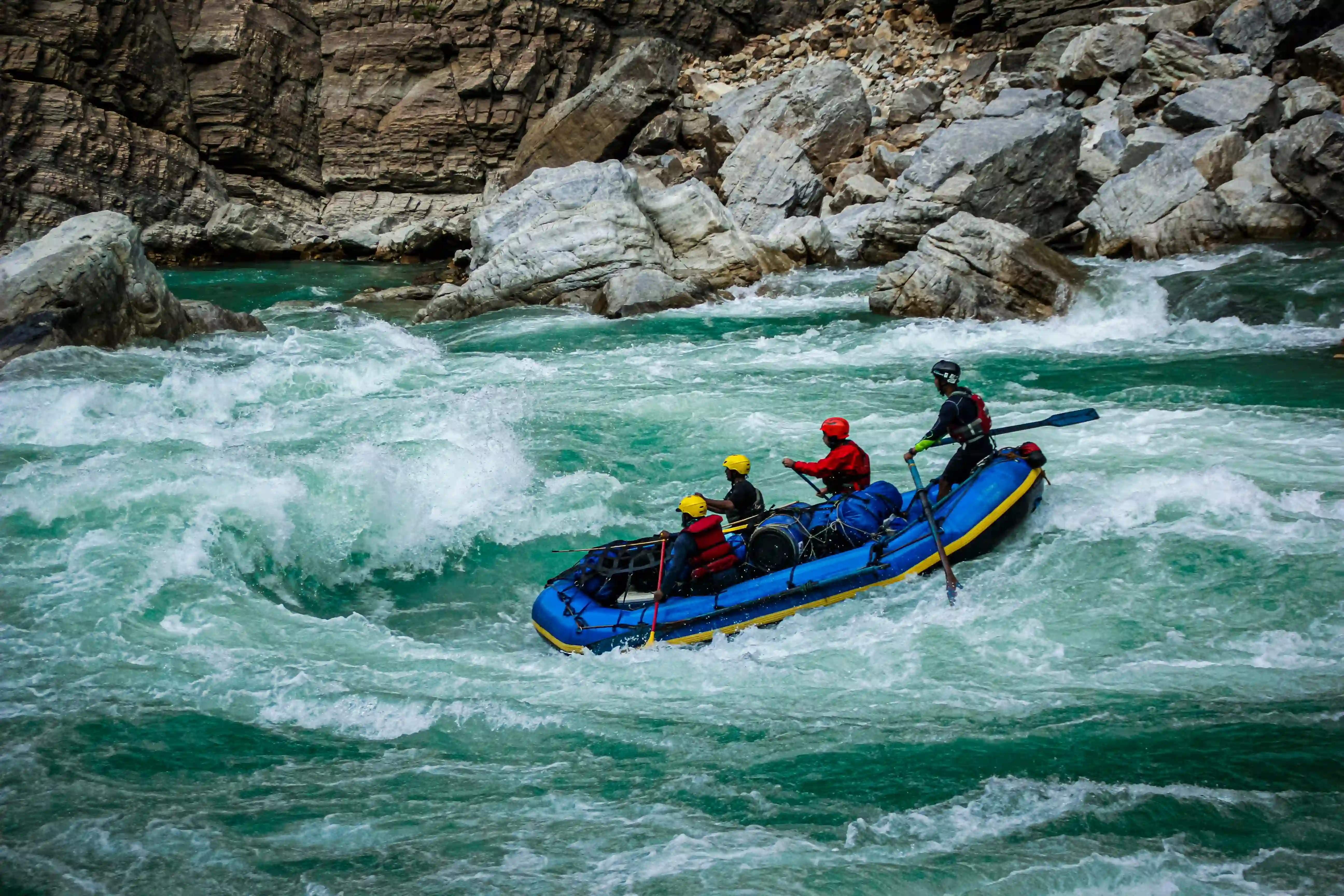 Group rafting down the Clear Creek, near the rocky bank